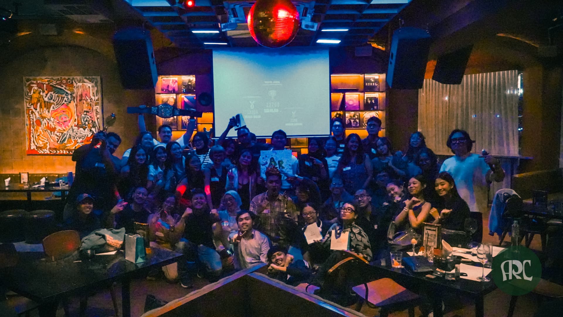 A large ARC community gathering celebrating together at a venue in Jakarta