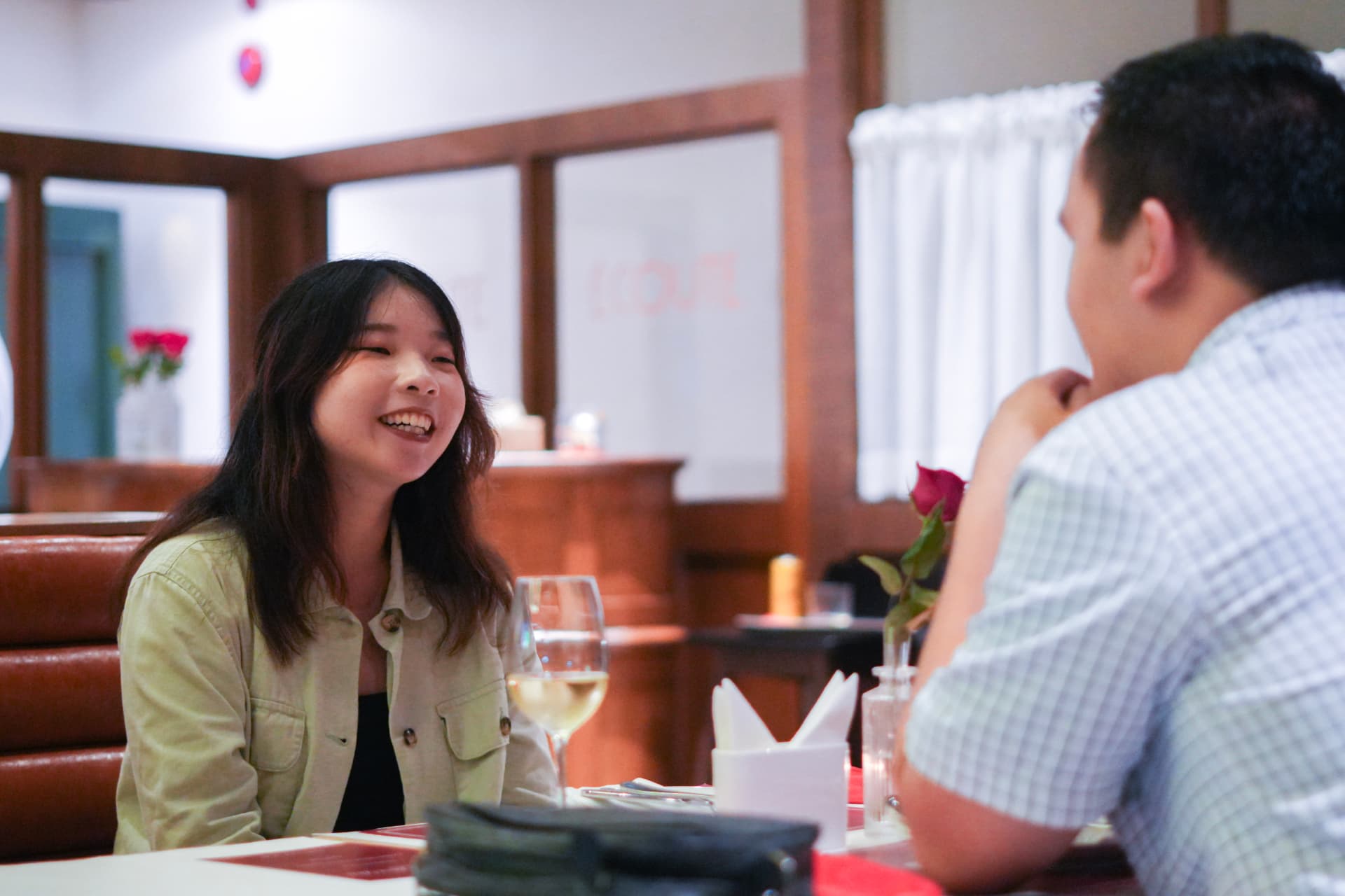 Two guests laughing across a candlelit table at an ARC SPARC social dinner